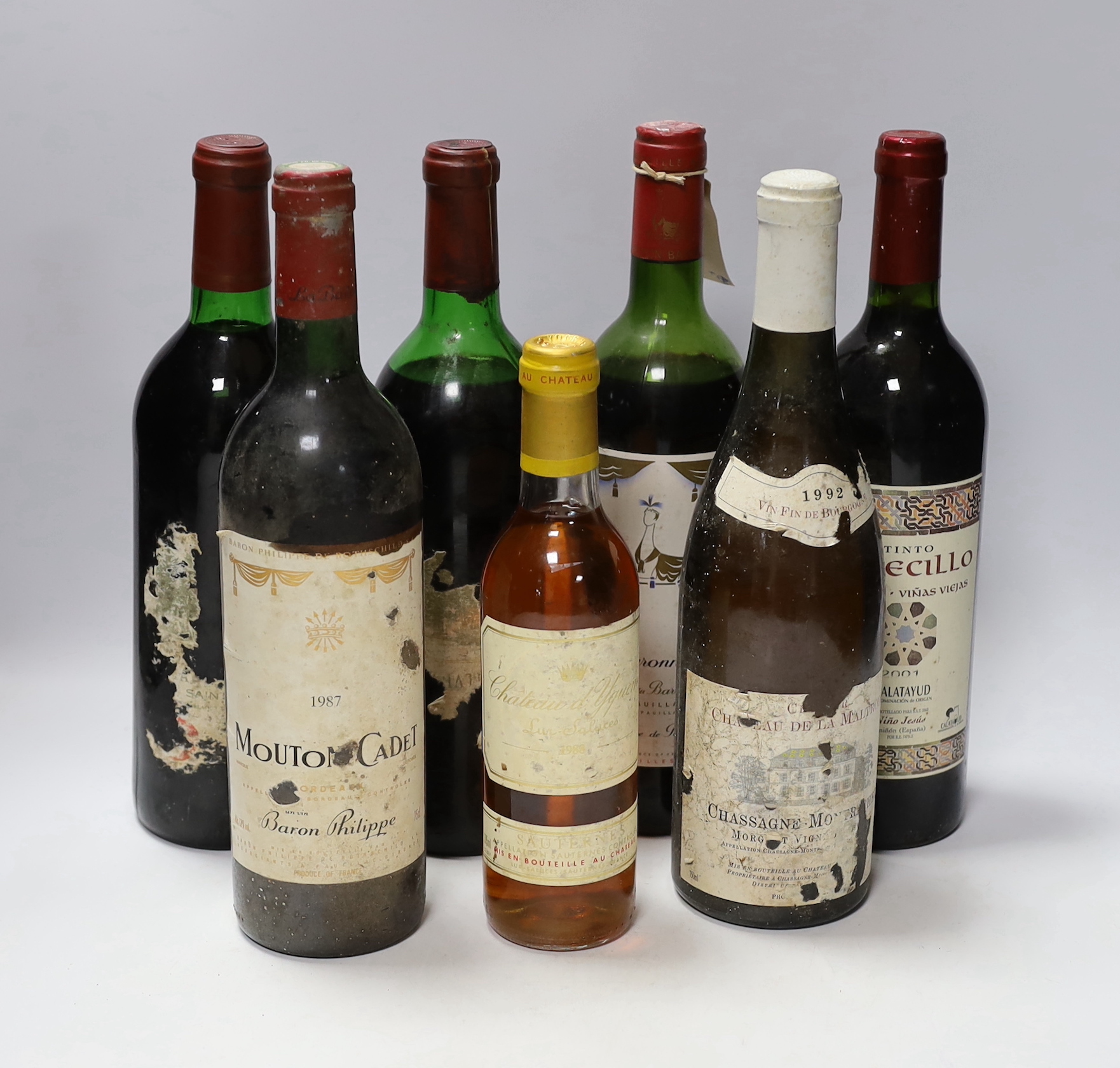 A half bottle of Chateau d'Yquem, 1988, a bottle of Chassagne Montrachet, 1992 and five assorted red wines including Chateau Mouton Baronne Philippe, 1977.